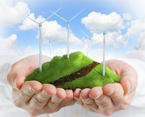 stock-photo-male-hands-holding-a-green-hill-with-wind-turbines-120662062